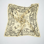 Flat lay of the Artefact Silk Scarf in soft yellow with black VARNA hand-drawn artwork
