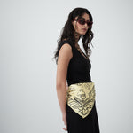 Detail shot of black illustrative motifs on the Artefact Silk Scarf