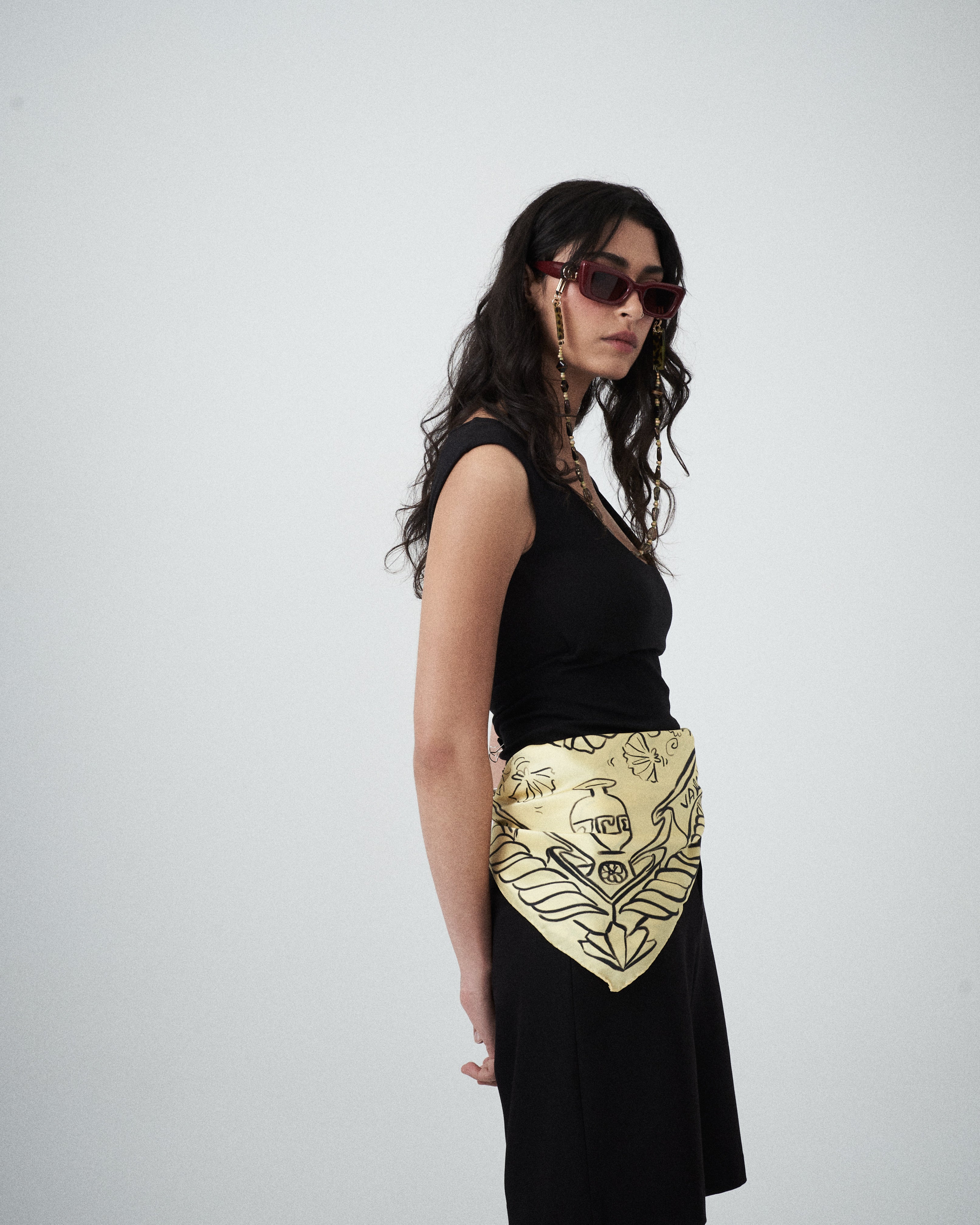 Detail shot of black illustrative motifs on the Artefact Silk Scarf