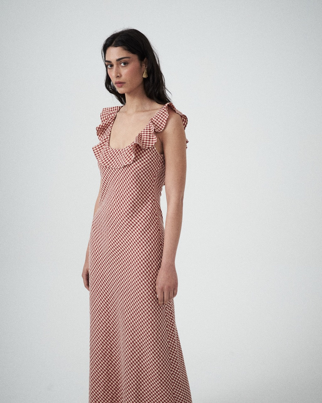 Mood shot featuring the Solan check bias  Ruffle Maxi Dress