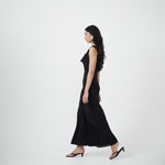 Woman wearing a Ariel black sleeveless dress on a white background