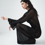 Sheer black knit designer maxi dress by VARNA, styled with refined accessories.