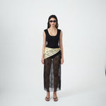 Editorial mood image of the VARNA Lucienne Maxi Lace Skirt in black — designer sheer floral lace skirt with straight silhouette and elegant drape.