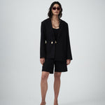 Editorial mood image of the VARNA Erica Oversized Blazer in black — designer relaxed tailoring with an effortless, modern silhouette.