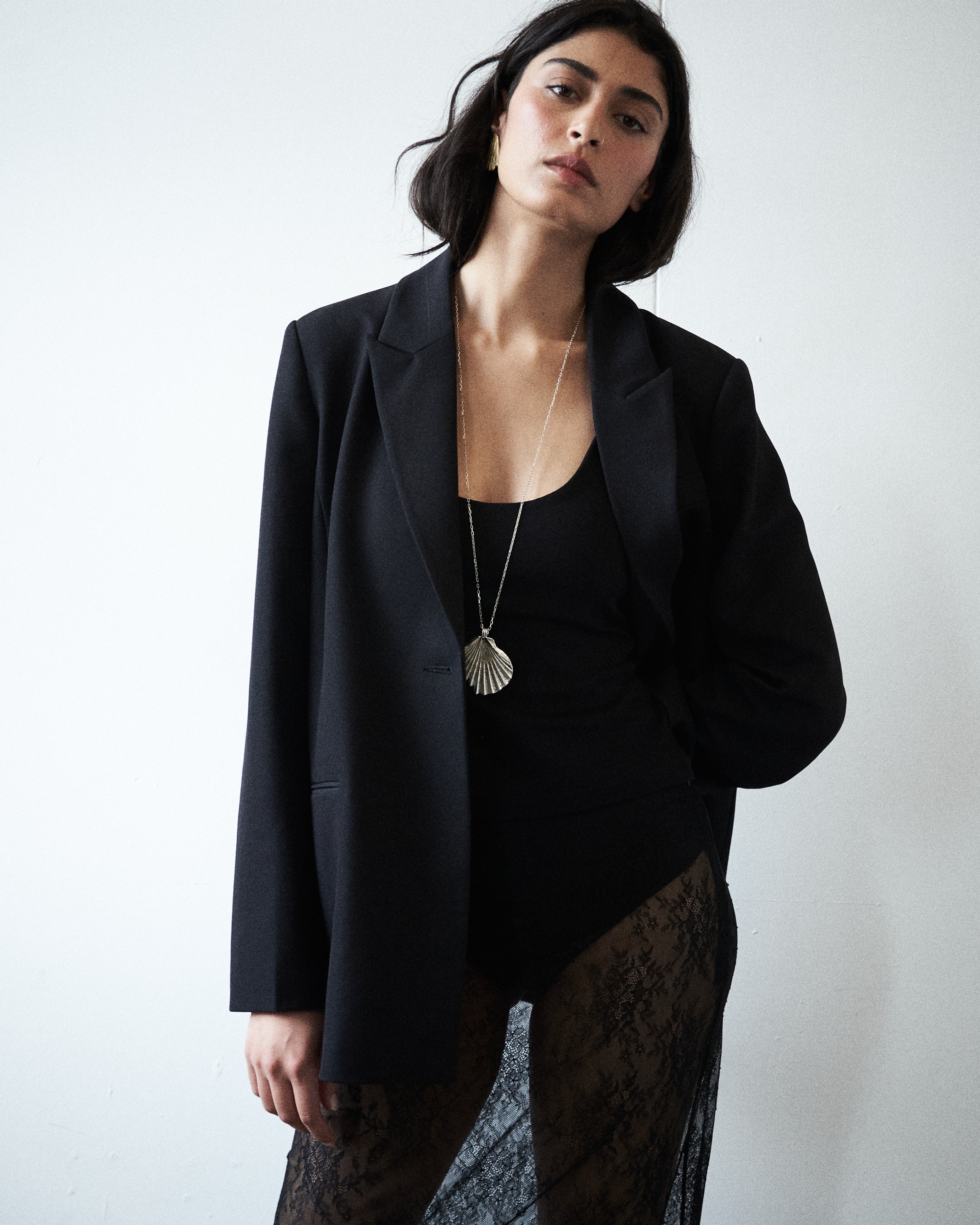 Campaign mood image of the VARNA Erica Oversized Blazer in black — structured, minimalist tailoring that embodies quiet power.