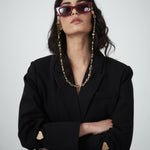 Editorial close-up of the VARNA Erica Oversized Blazer in black showing tonal button detailing and minimalist tailoring.