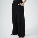 Close-up of VARNA Enrica Relaxed Tailored Pant in black showing front tuck detailing and refined finish.