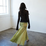 Back view of the VARNA Arden Full Maxi Skirt in pear silk showing high waist, soft drape, and flowing movement.