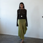 Editorial front view of the VARNA Arden Full Maxi Skirt in pear silk — designer high-waisted skirt with full, fluid silhouette.