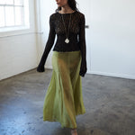 Second editorial front image of VARNA Arden Full Maxi Skirt in pear — 100% silk skirt with elegant volume and refined sheen.