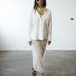 Second editorial mood image of the VARNA Rhea Shirt — minimalist white cotton shirt styled with quiet sophistication.