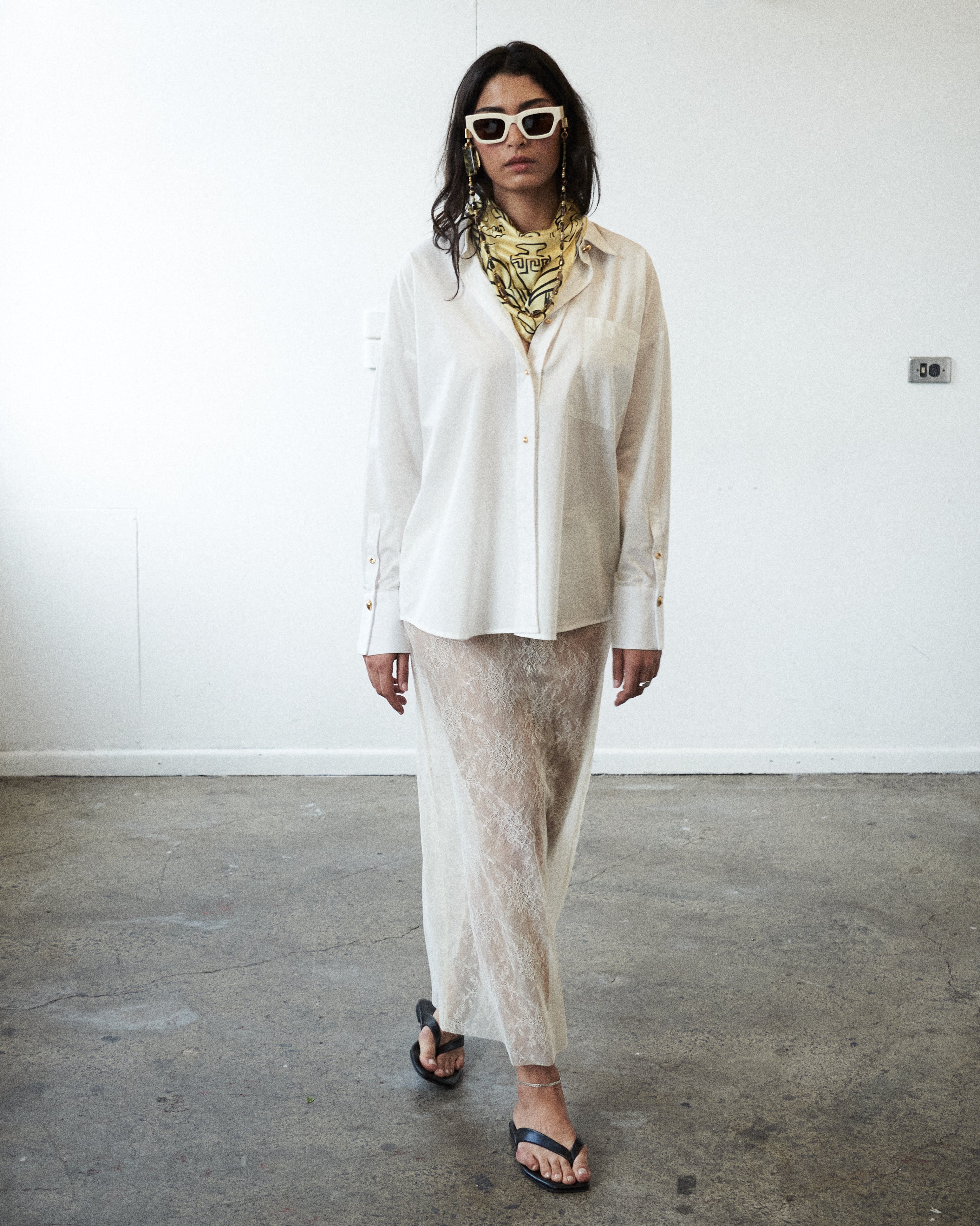 Second editorial mood image of the VARNA Rhea Shirt — minimalist white cotton shirt styled with quiet sophistication.