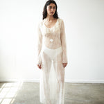 Editorial close-up of the VARNA Lucienne Ruffle Lace Maxi Dress in milk — delicate floral lace with ruffled neckline