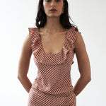 Mood shot featuring the Solan check bias Ruffle Maxi Dress