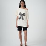 Model wearing the Valencia Off-The-Shoulder Tee in Milk, front view