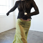 Close-up of VARNA Arden Full Maxi Skirt in pear showing smooth 100% silk texture and soft sheen.