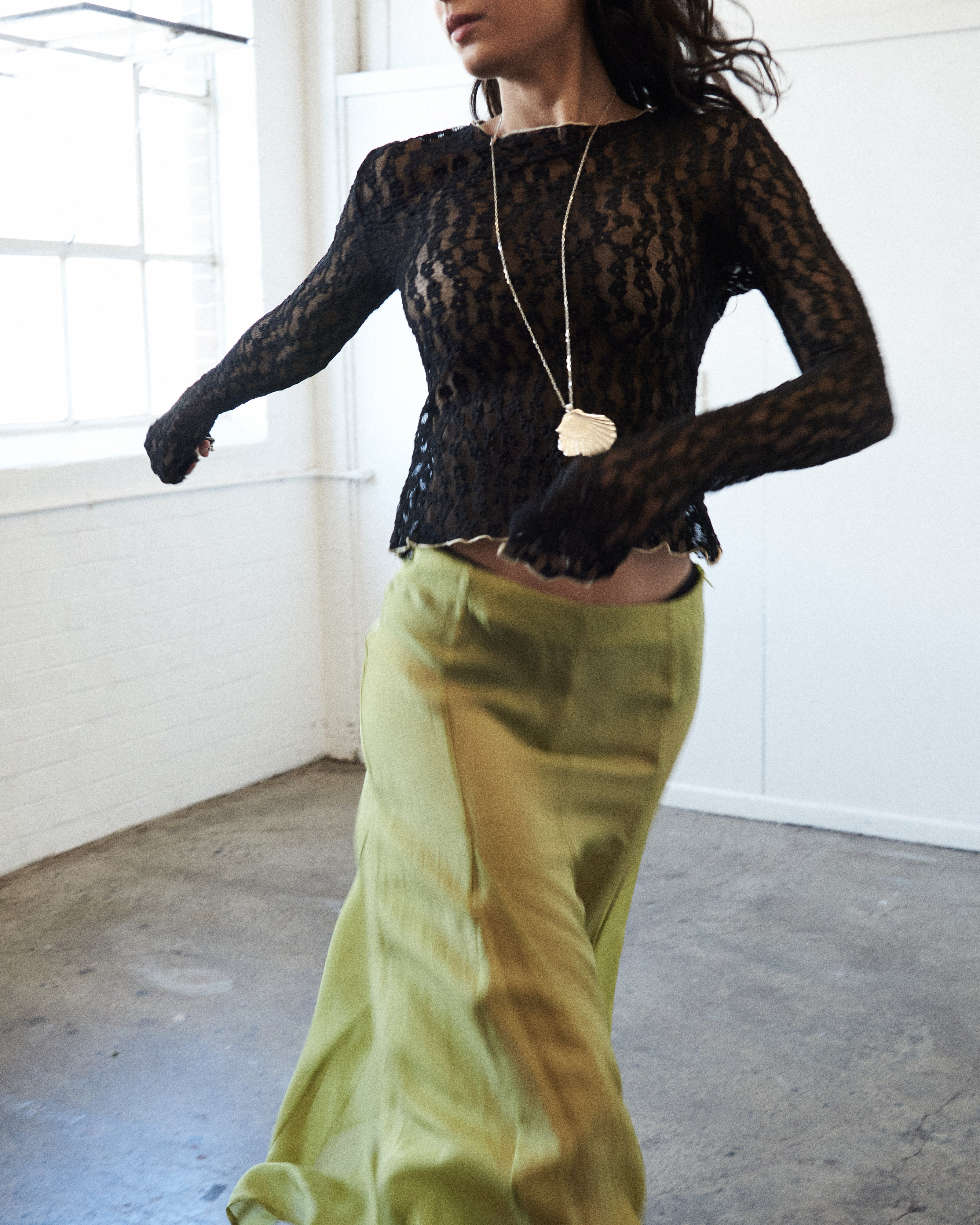 Close-up of VARNA Arden Full Maxi Skirt in pear showing smooth 100% silk texture and soft sheen.