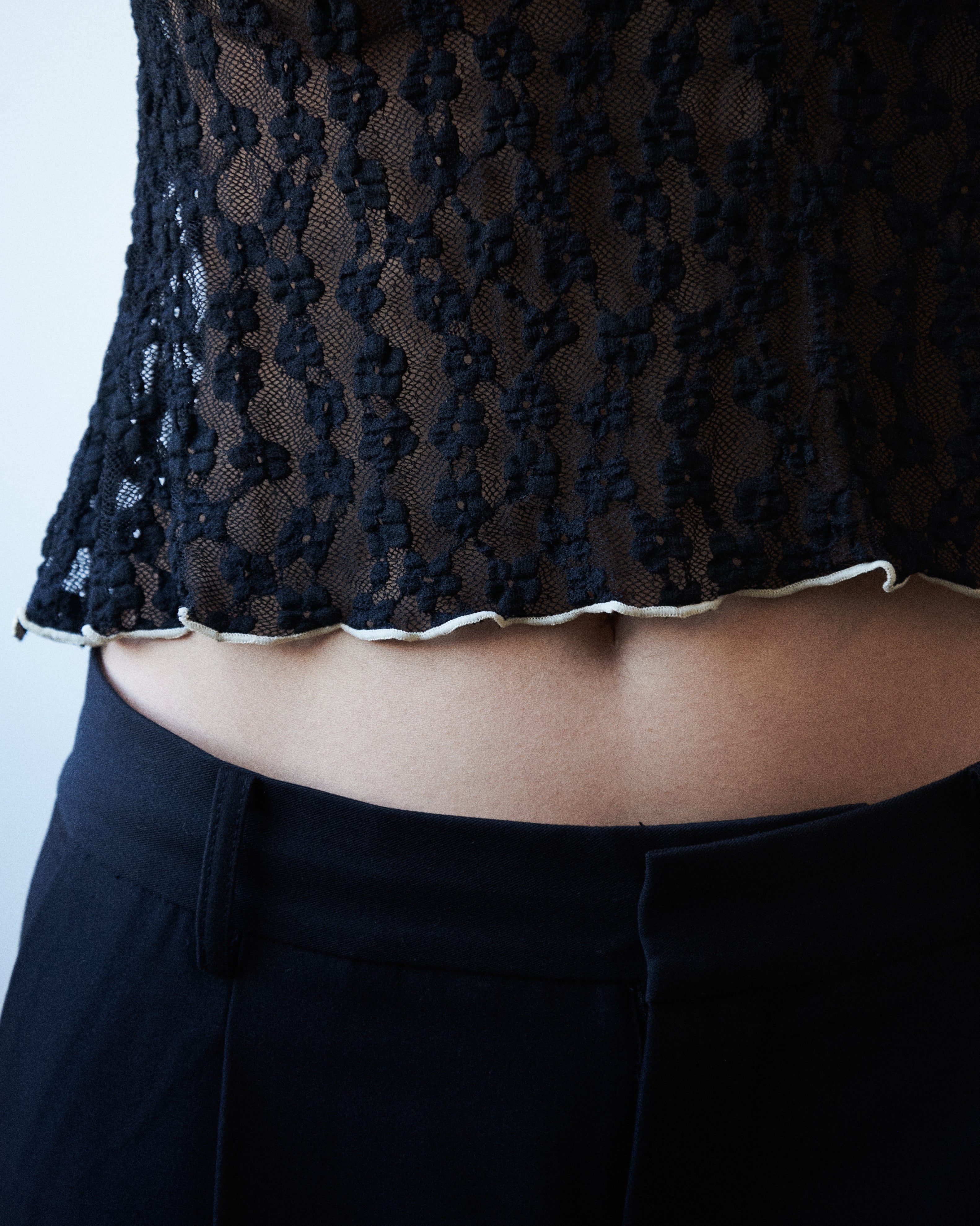 Close-up of VARNA Cecil Lace Top showing floral lace pattern and lettuce-edge detail.
