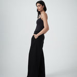 Three-quarter view of VARNA Enrica Relaxed Tailored Pant in black highlighting fluid drape and tailored silhouette.