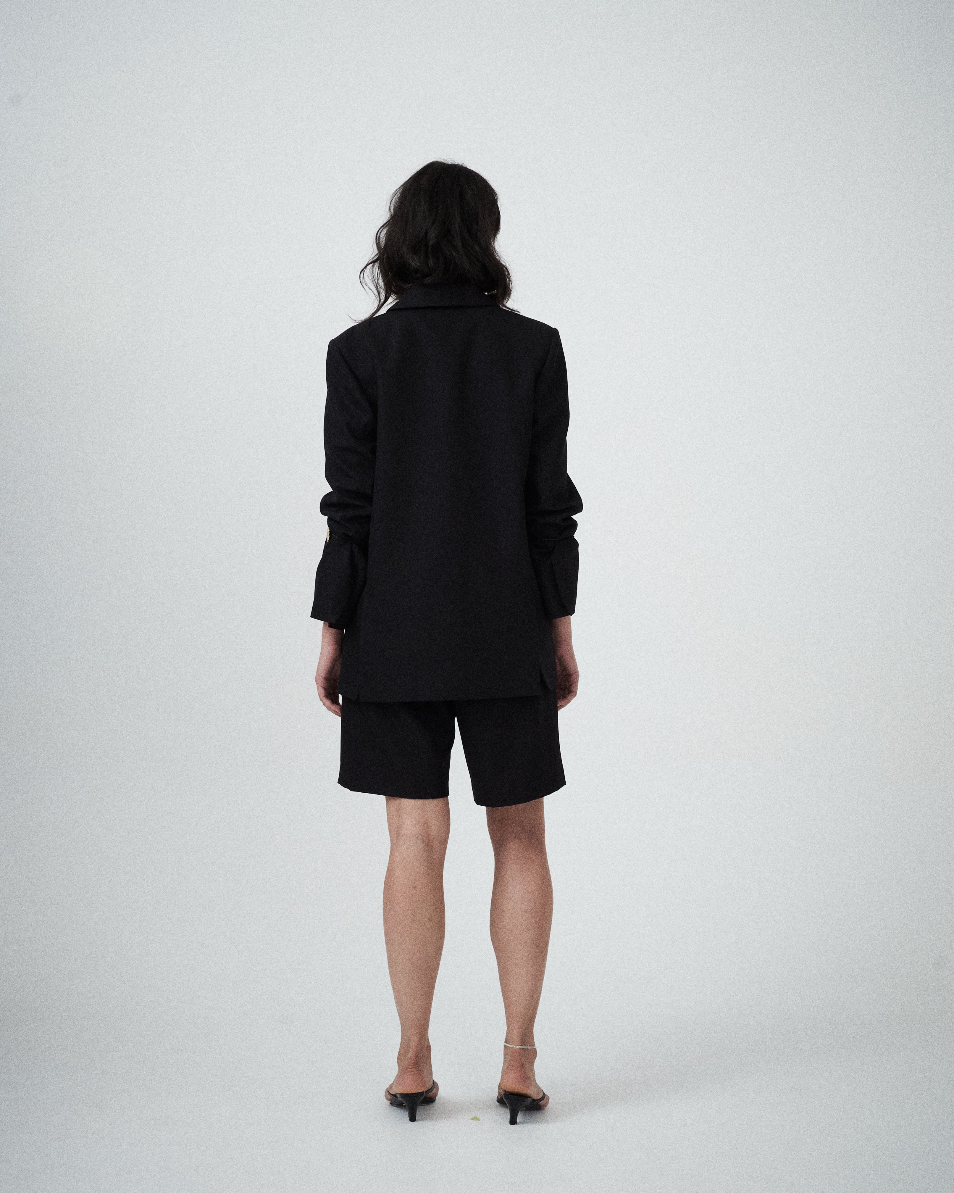 Back view of VARNA Erica Oversized Blazer in black featuring a relaxed fit and refined silhouette.