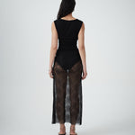 Back view of VARNA Lucienne Maxi Lace Skirt in black floral lace with sheer finish and refined scalloped detailing.