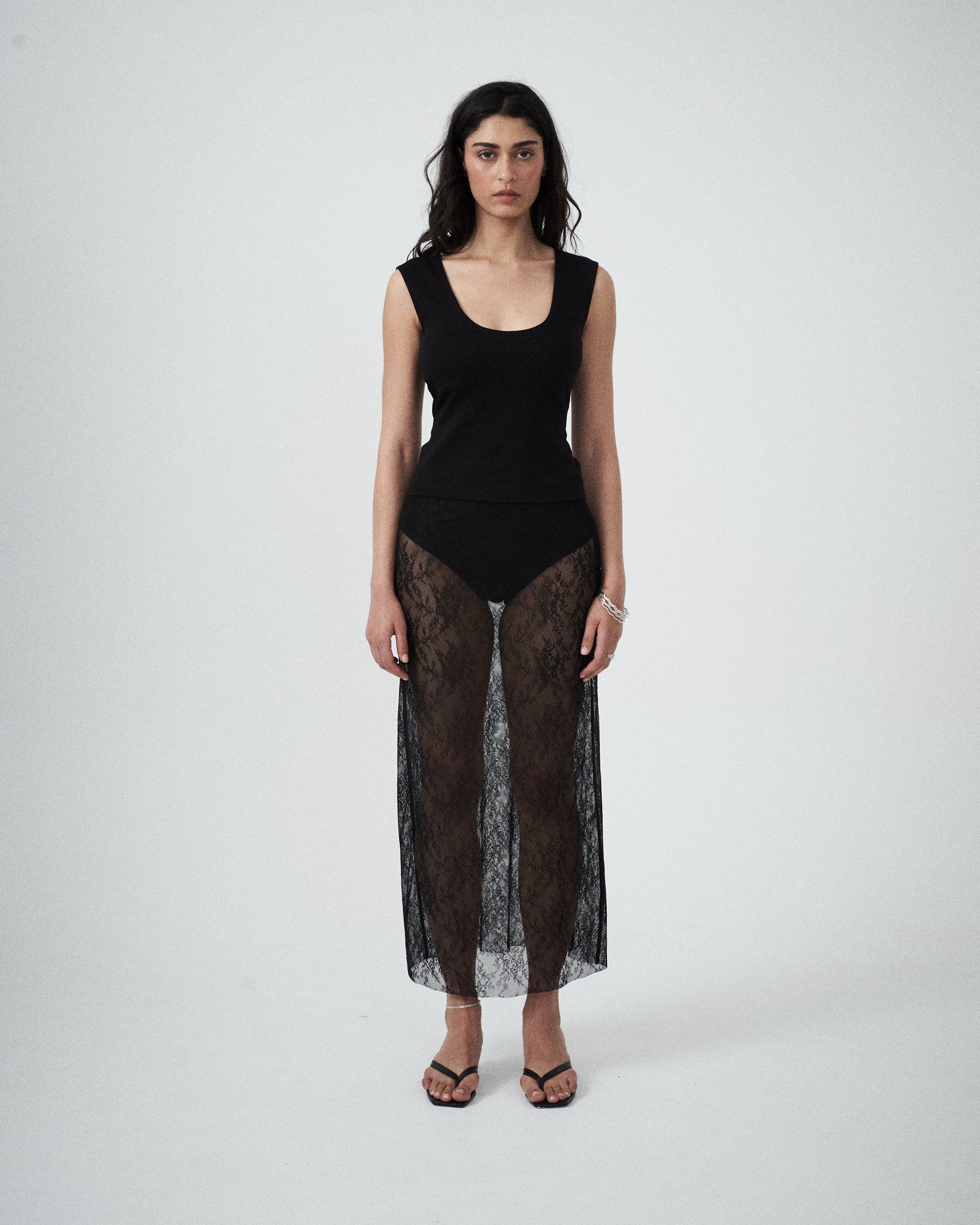 Front view of VARNA Lucienne Maxi Lace Skirt in black floral lace showing sheer finish, straight silhouette, and delicate texture.