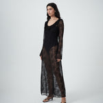 Three-quarter view of VARNA Lucienne Ruffle Lace Maxi Dress in black highlighting fluted sleeves and low back tie.