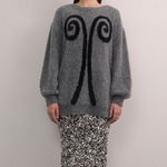 Front view of VARNA Maris Knit Top in charcoal alpaca-wool blend showing abstract motif and oversized silhouette.