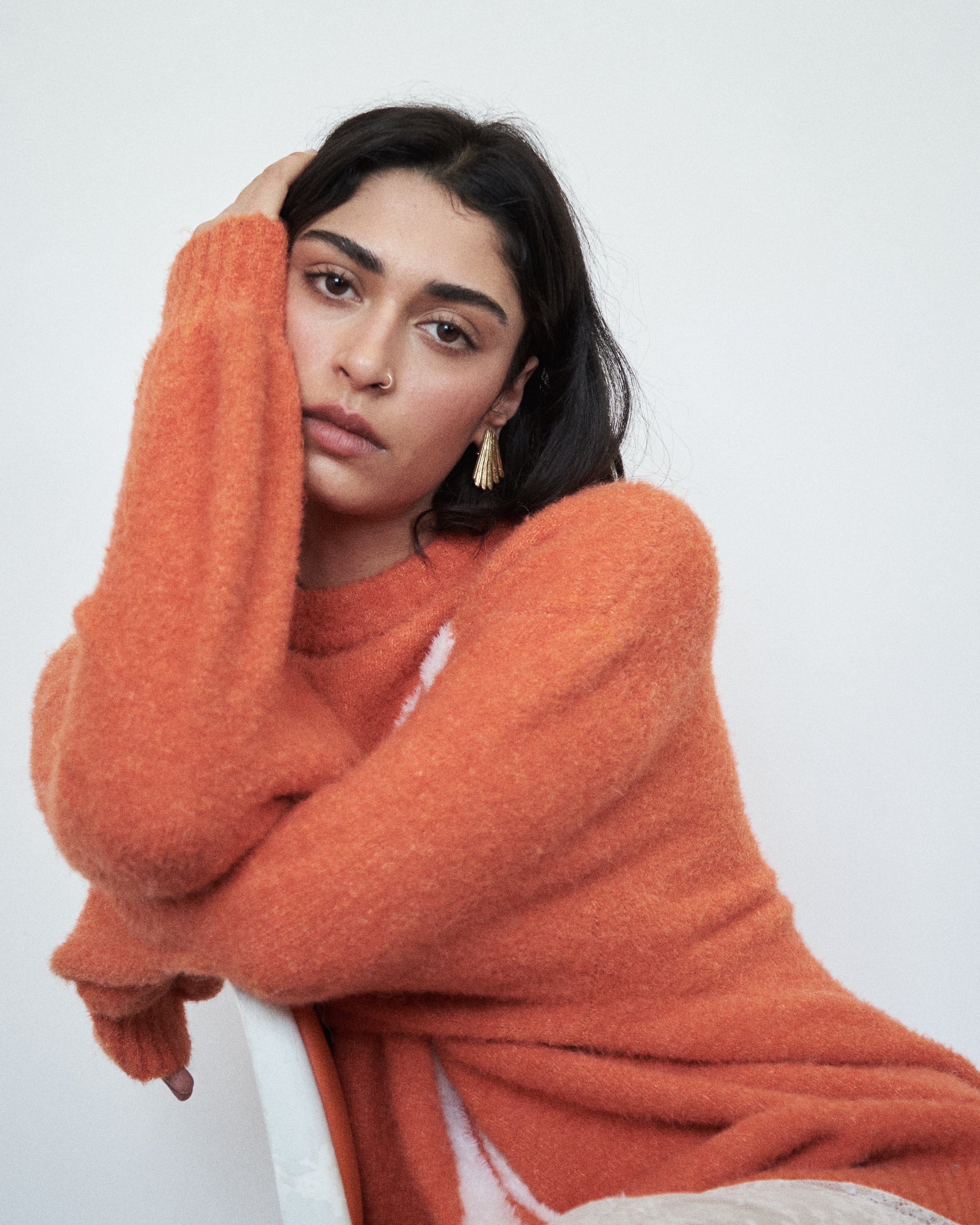 VARNA Maris Knit Top in tangerine alpaca-wool blend styled in a relaxed mood setting — oversized fit with statement sleeves.