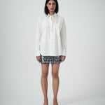 Front view of VARNA Rhea Shirt in crisp white cotton with gold-tone buttons and relaxed fit.
