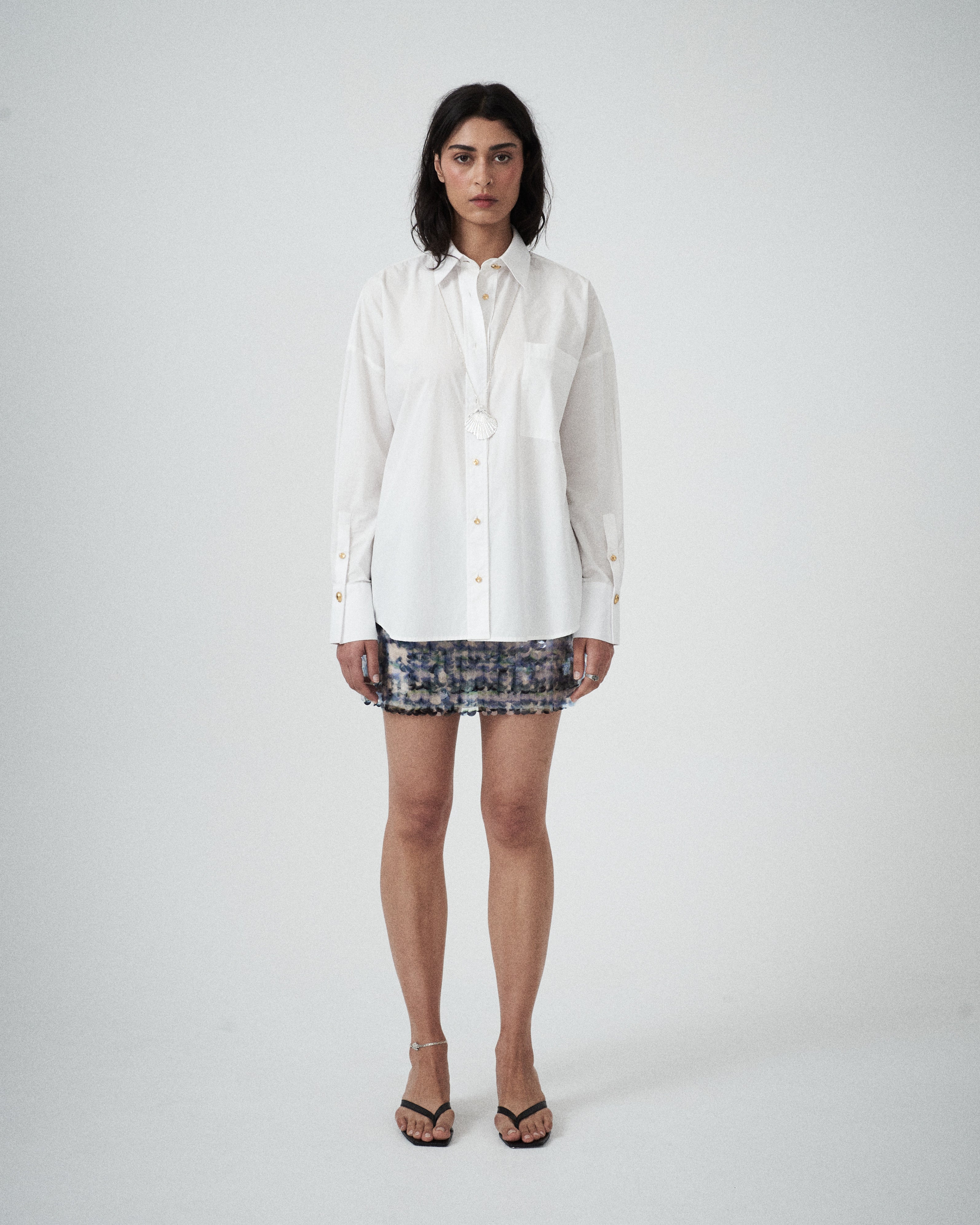 Front view of VARNA Rhea Shirt in crisp white cotton with gold-tone buttons and relaxed fit.
