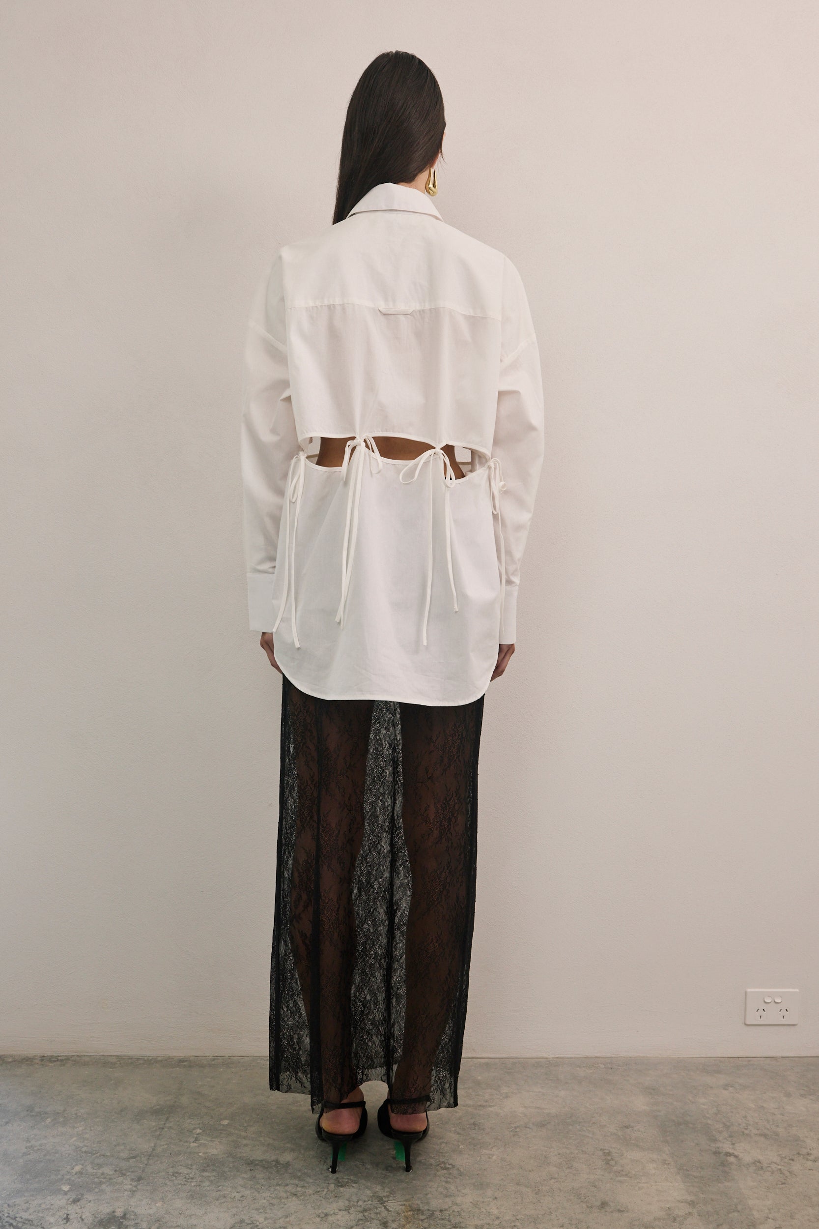 VARNA Rhea Tied Shirt in crisp white cotton with relaxed silhouette and cut-out waist detail.