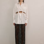 Designer white cotton shirt by VARNA with statement cut-outs and side ties.
