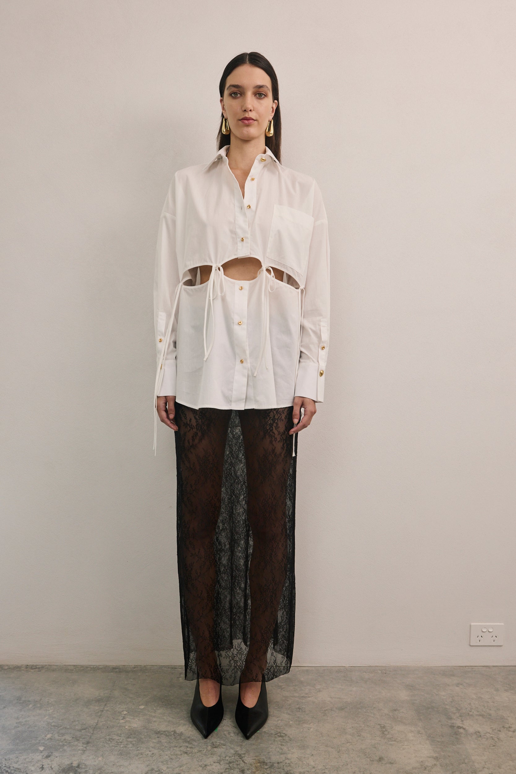 Designer white cotton shirt by VARNA with statement cut-outs and side ties.