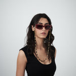 Model styling black scoop neck jersey tank with sunglasses and chain