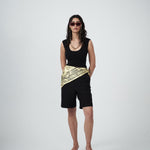 Model wearing black tank with scoop neckline