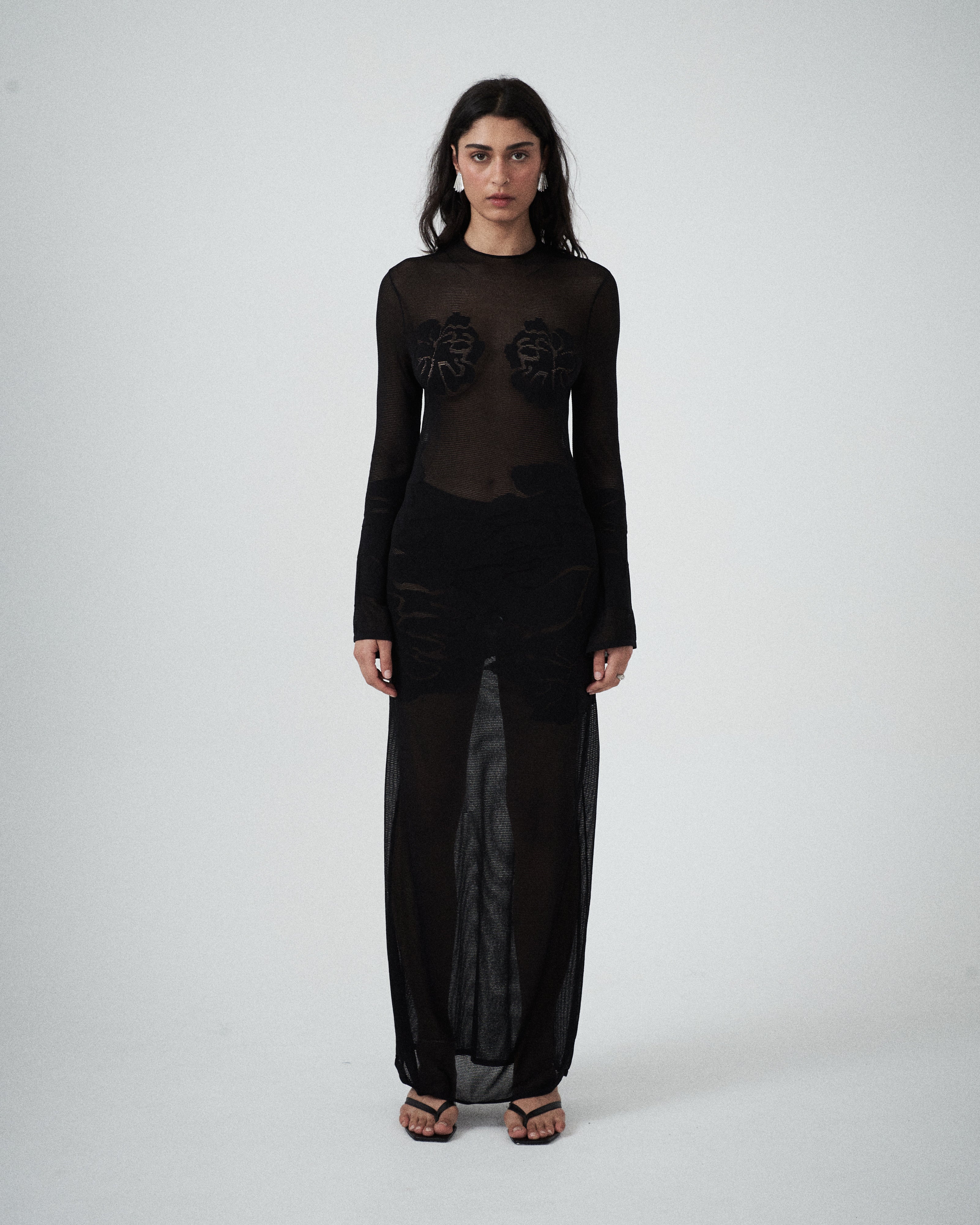 Close-up of VARNA Seraphine Knit Maxi Dress showing floral detail on sheer black knit.