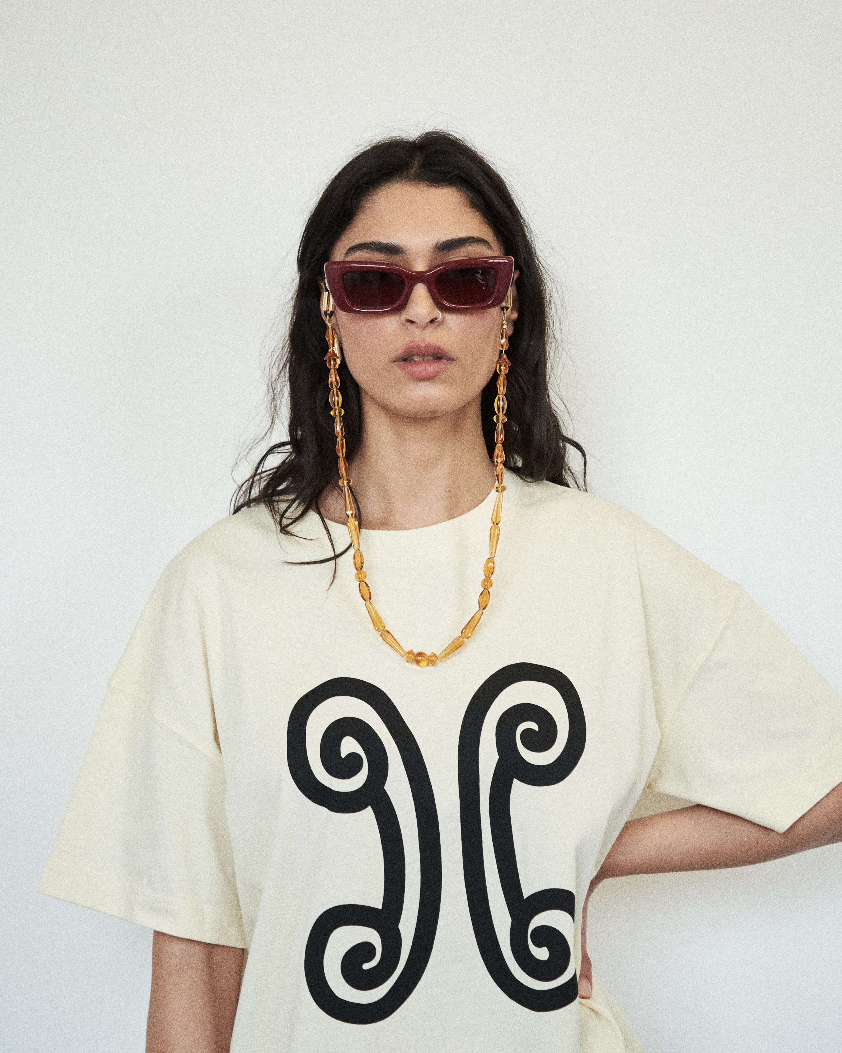 Close-up of VARNA Valencia Tee showing abstract emblem print on premium cotton.